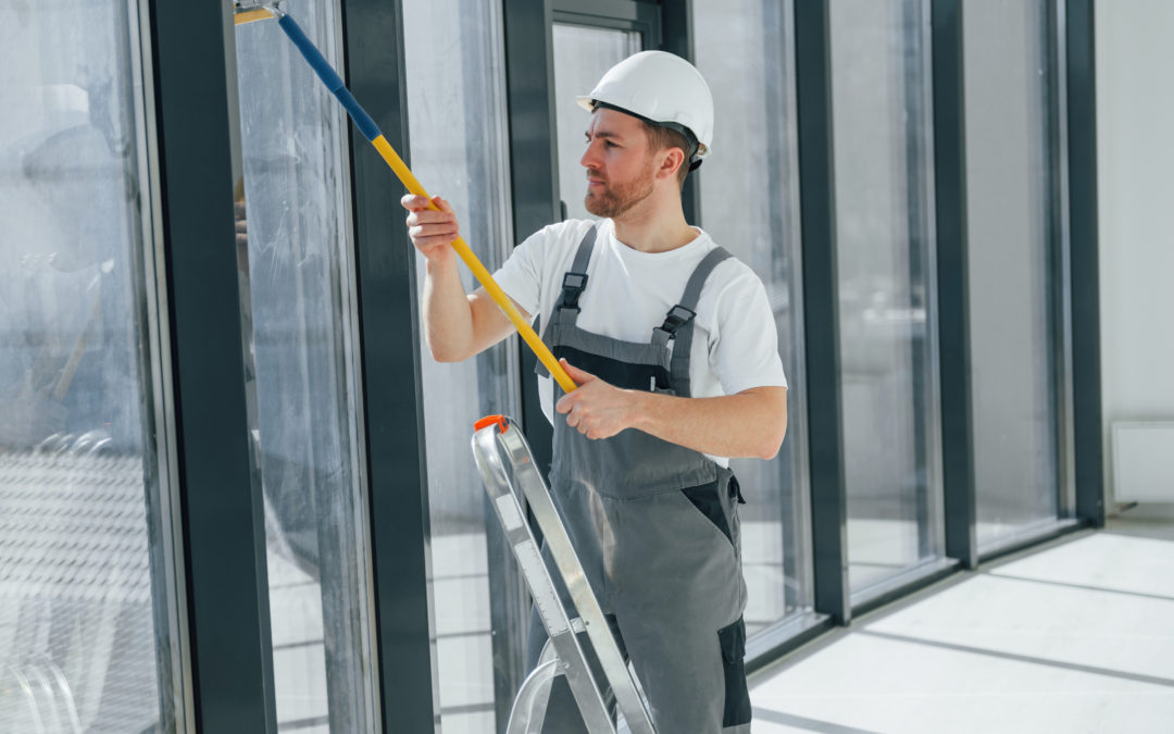 A skilled worker cleaning the windows of a commercial building