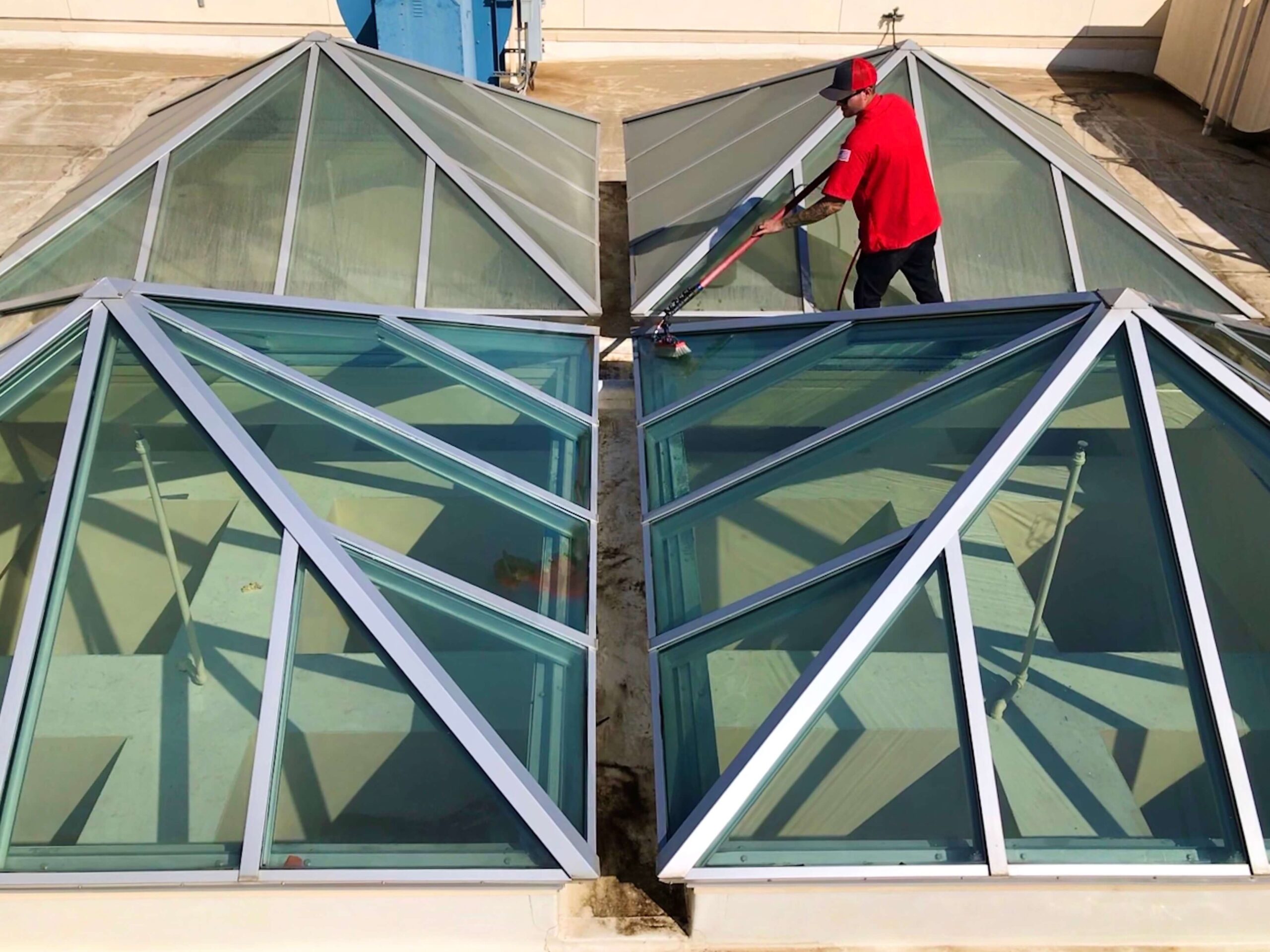 A skilled worker cleaning the windows of a commercial building