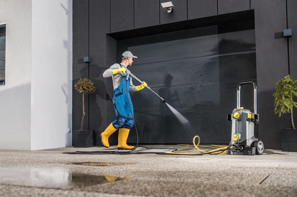 Caucasian,Men,Pressure,Washing,His,Garage,Gate,Using,Powerful,Washer. Solar Panel Cleaning in CA