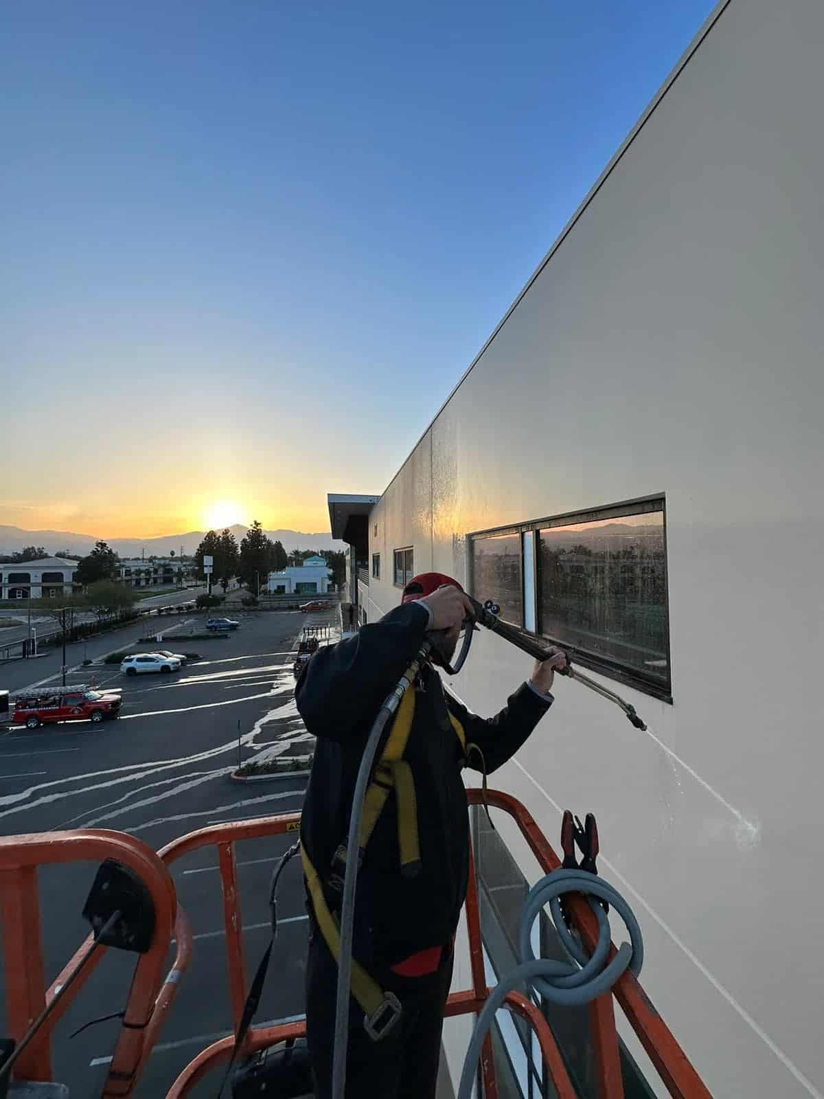 Cleaning large windows with the support of a ladder